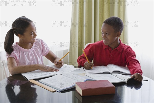 Brother and sister (10-13) doing homework. Photo : Rob Lewine