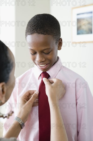 Mother adjusting Son's (12-13) tie. Photo : Rob Lewine