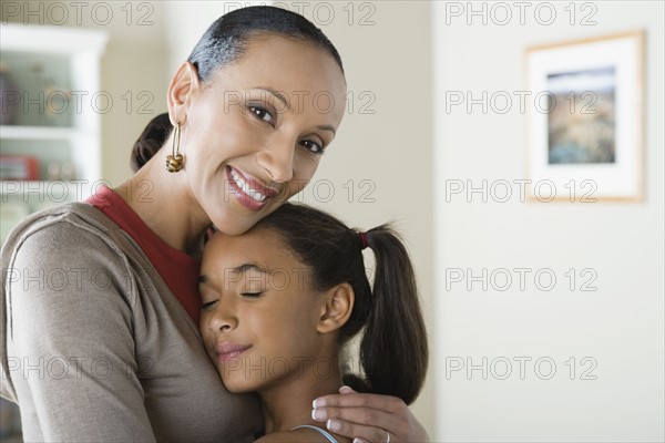 Portrait of Mother hugging Daughter (10-11). Photo : Rob Lewine