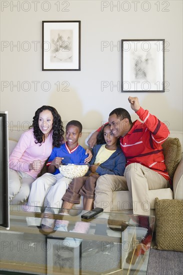 Parents and children (10-13) watching tv. Photo : Rob Lewine