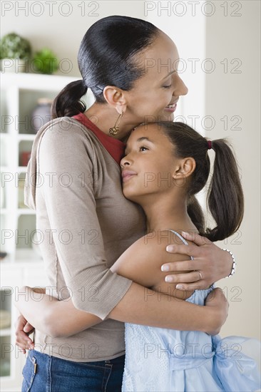 Mother and Daughter (10-11) hugging. Photo : Rob Lewine