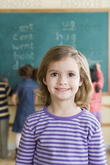 Portrait of girl (6-7) in classroom. Photo : Rob Lewine