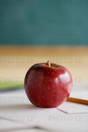 Red apple on teacher's desk. Photo : Rob Lewine