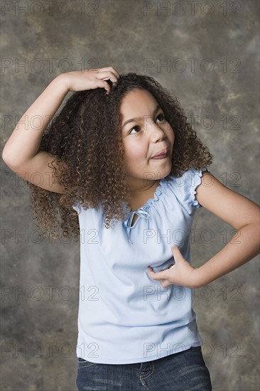 Portrait of girl (8-9) making face, studio shot. Photo: Rob Lewine