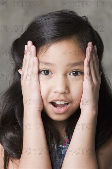 Portrait of surprised girl (8-9), studio shot. Photo: Rob Lewine