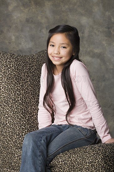 Portrait of smiling girl (8-9), studio shot. Photo : Rob Lewine