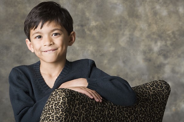 Portrait of smiling boy (8-9), studio shot. Photo : Rob Lewine