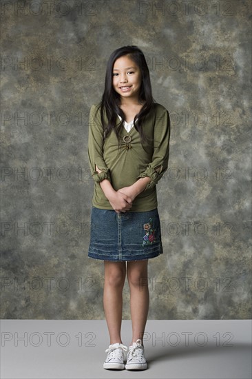 Portrait of smiling girl (8-9), studio shot. Photo : Rob Lewine