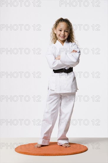 Girl (8-9) wearing gi, studio shot. Photo : Rob Lewine