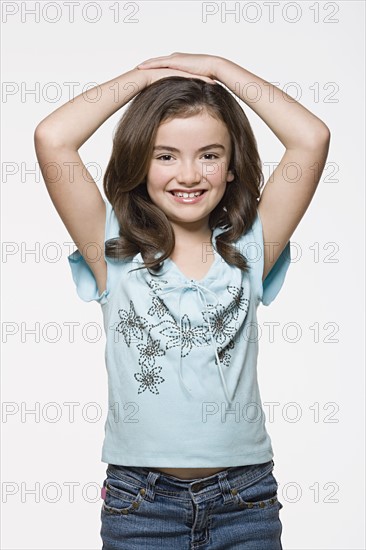 Studio portrait of smiling girl (8-9). Photo: Rob Lewine