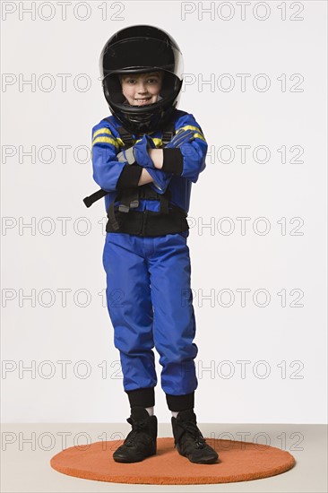 Studio portrait of girl (8-9) in crash helmet. Photo : Rob Lewine