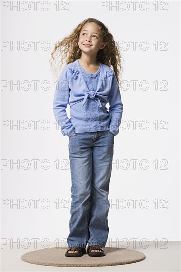 Studio portrait of smiling girl (8-9). Photo : Rob Lewine