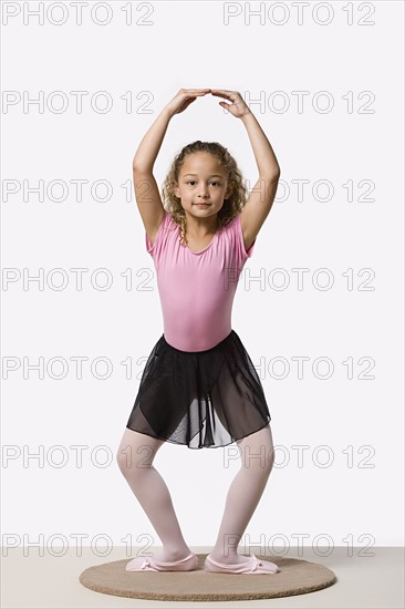 Studio portrait of ballet dancer (8-9) exercising. Photo: Rob Lewine