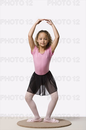 Studio portrait of ballet dancer (8-9) exercising. Photo : Rob Lewine