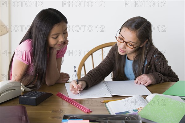 Sisters (8-9, 10-11) doing homework. Photo : Rob Lewine