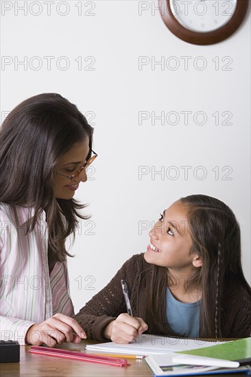 Mother doing homework with daughter (10-11). Photo : Rob Lewine