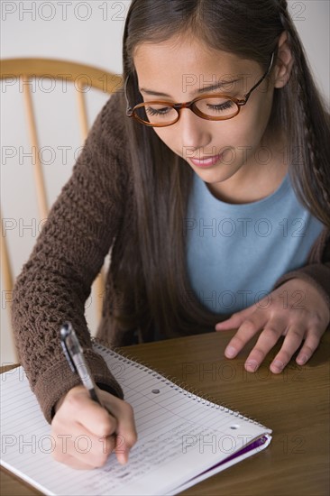 Girl (10-11) doing homework. Photo : Rob Lewine