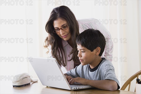 Mother doing homework with son (10-11). Photo : Rob Lewine