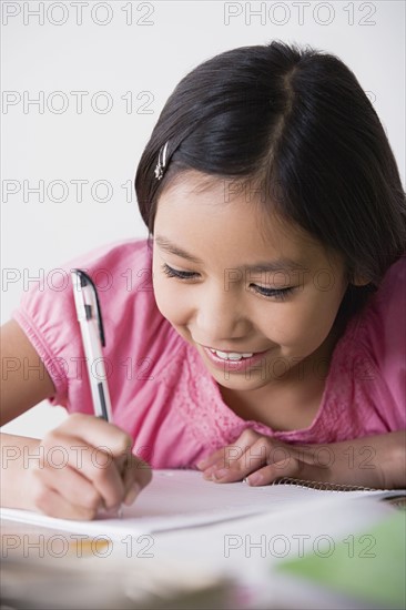 Boy (8-9) doing homework. Photo : Rob Lewine