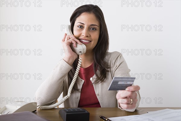 Portrait of smiling woman talking on phone. Photo : Rob Lewine