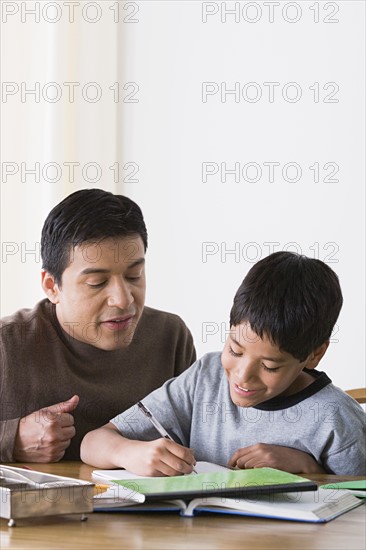 Father doing homework with son (10-11). Photo : Rob Lewine