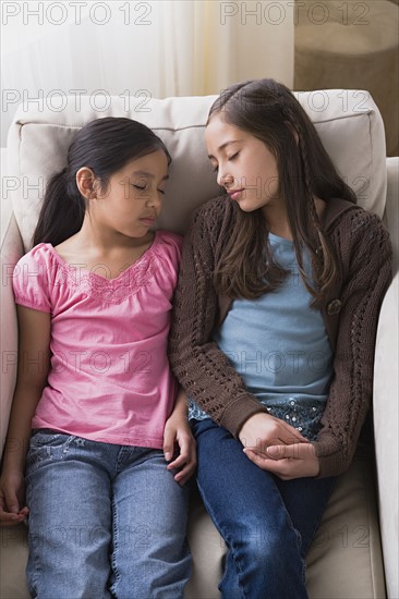 Girls (8-9, 10-11) sleeping in armchair. Photo: Rob Lewine