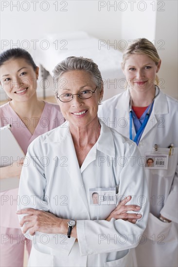 Portrait of three smiling female doctors. Photo : Rob Lewine