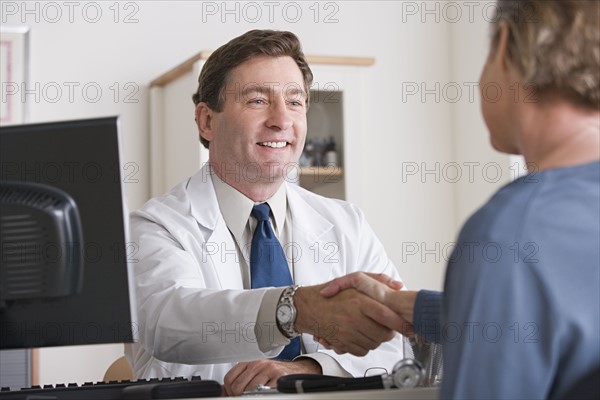 Male doctor shaking hand with patient. Photo: Rob Lewine