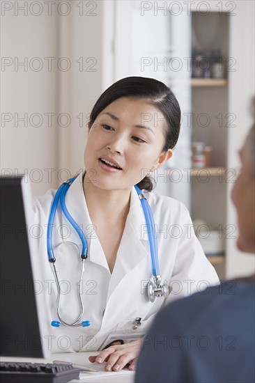 Female doctor talking to patient . Photo : Rob Lewine