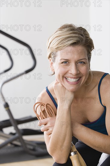 Portrait of smiling woman in gym. Photo : Rob Lewine