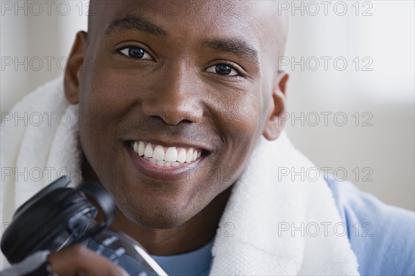 Portrait of smiling young man in gym. Photo: Rob Lewine