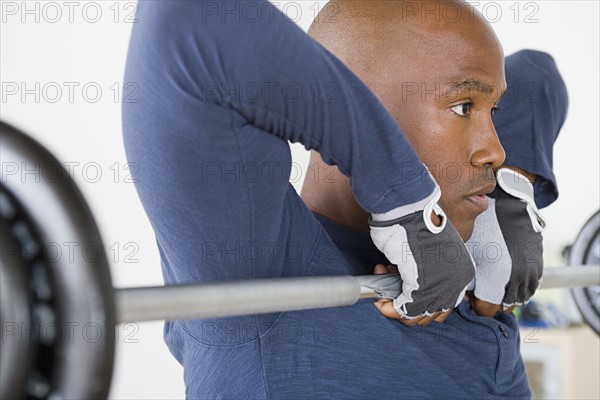 Man lifting barbell in gym. Photo: Rob Lewine