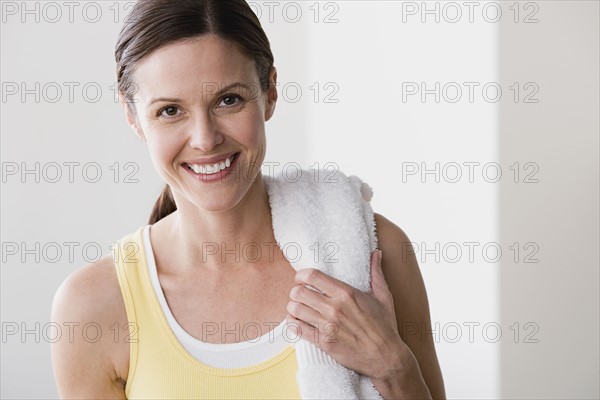 Portrait of smiling woman in gym. Photo : Rob Lewine