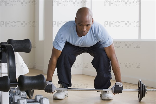 Athlete lifting barbell. Photo : Rob Lewine