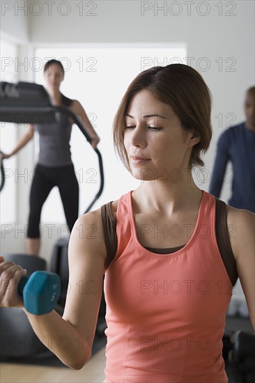 Three people exercising in gym. Photo : Rob Lewine