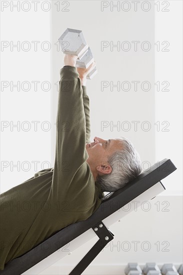 Man lifting dumbbells. Photo: Rob Lewine