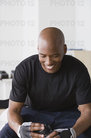 Male athlete smiling in gym. Photo : Rob Lewine