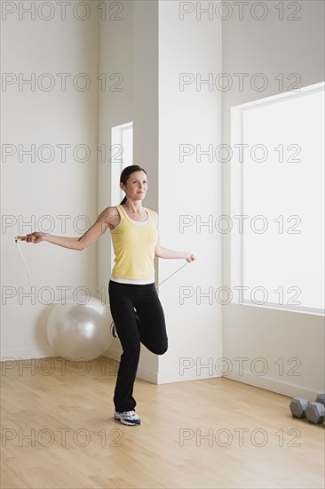 Woman exercising with jump rope. Photo : Rob Lewine