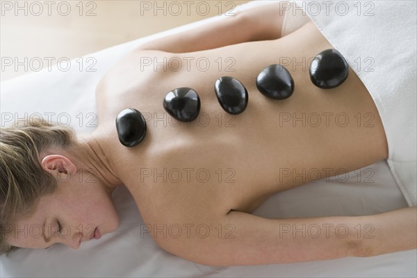 Woman receiving hot stone therapy. Photo : Rob Lewine