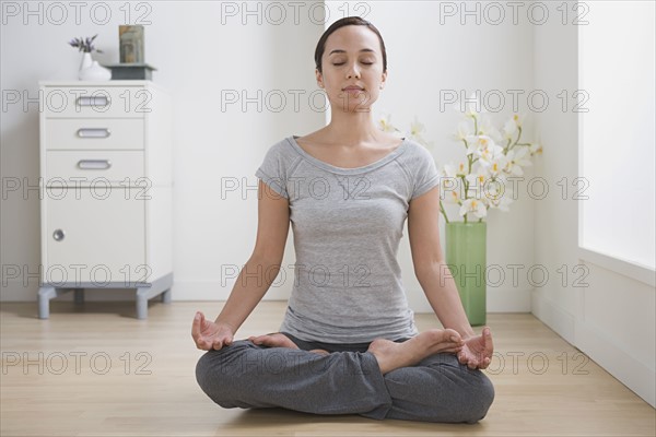 Woman meditating at home. Photo: Rob Lewine