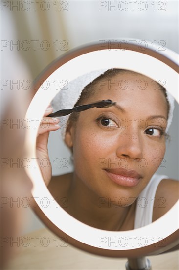 Woman brushing eyebrow. Photo: Rob Lewine