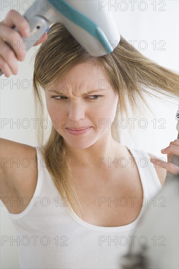 Woman drying hair. Photo : Rob Lewine