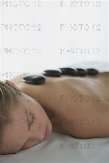 Woman enjoying hot stone therapy. Photo: Rob Lewine