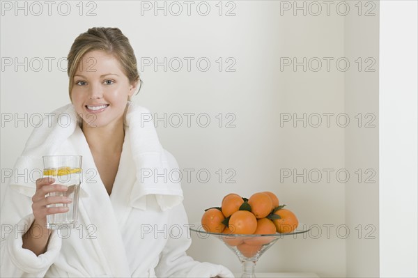 Relaxed woman drinking water. Photo : Rob Lewine