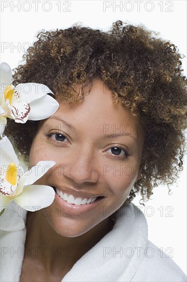 Portrait of attractive woman with tropical flowers. Photo : Rob Lewine