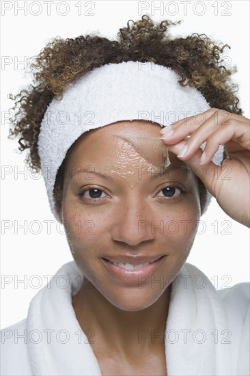 Portrait of attractive woman with facial mask. Photo : Rob Lewine