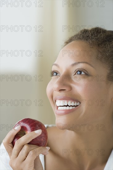 Attractive woman holding apple. Photo : Rob Lewine