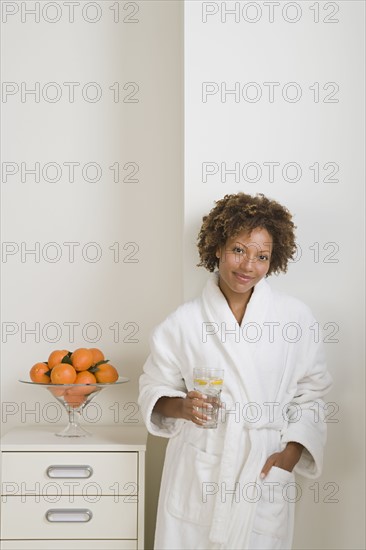 Attractive woman drinking fresh orange juice. Photo : Rob Lewine
