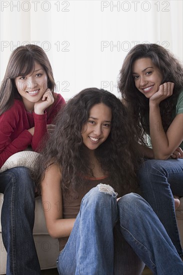 Portrait of three young women smiling. Photo : Rob Lewine