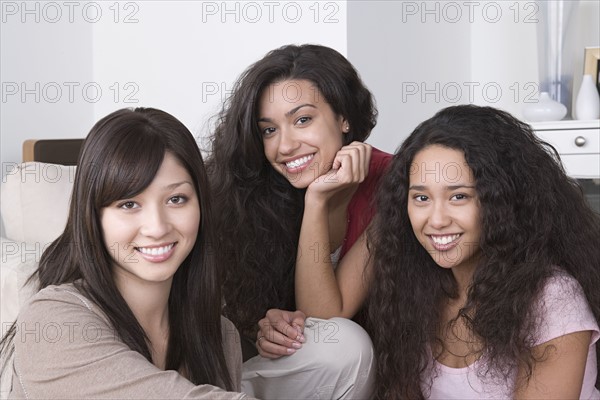 Portrait of three young women smiling. Photo : Rob Lewine